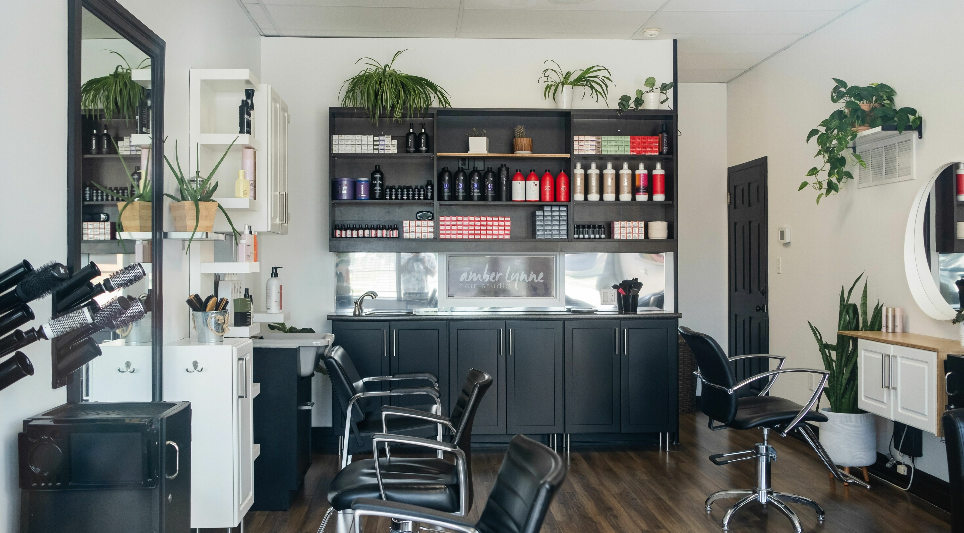 Interior of Amber Lynne Hair Studio in Hamilton, Ontario, CA showcasing stylish chairs and hair products.