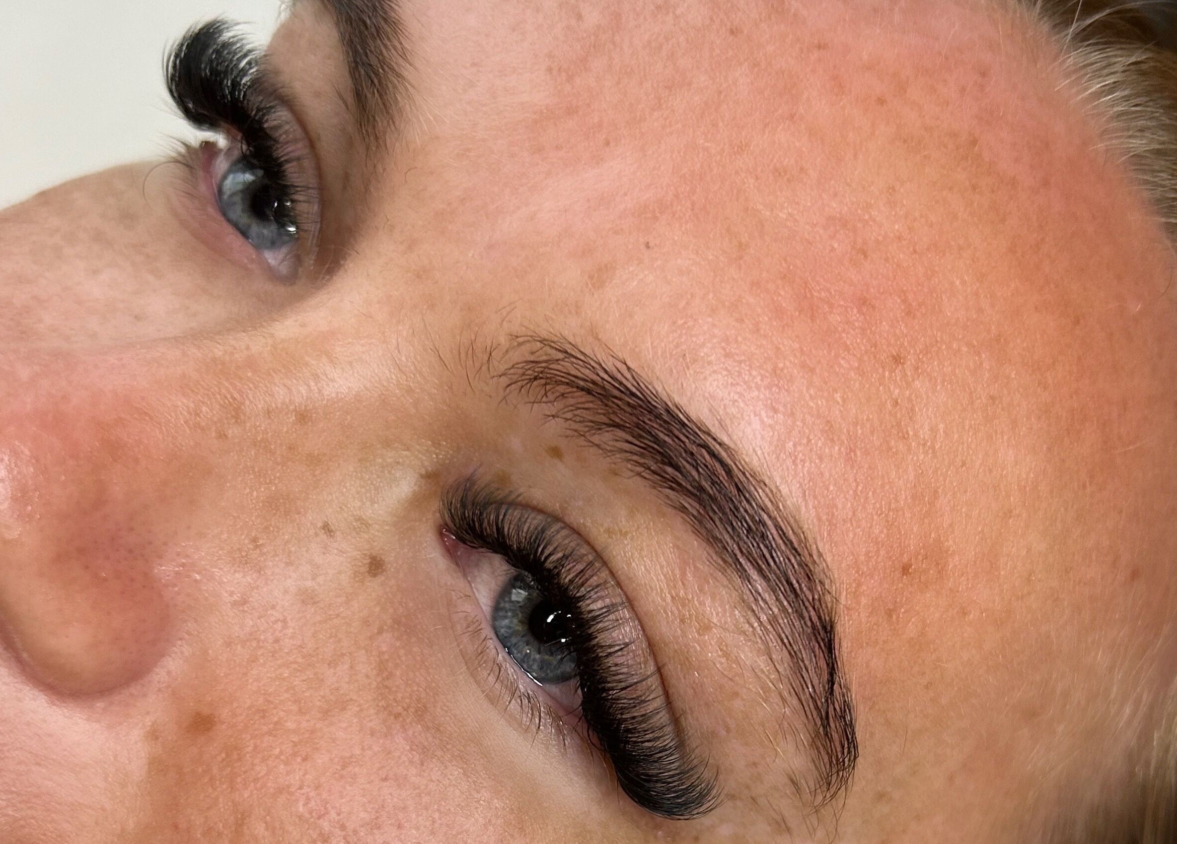 Close-up of enhanced eyelashes at House of Belle, Rushden, England, GB showcasing precise lash extension work.