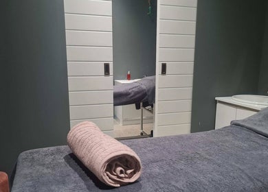 Serene treatment room at Posh Pamper Specialists, Cape Town, Western Cape, ZA, with soft towels and calming decor.