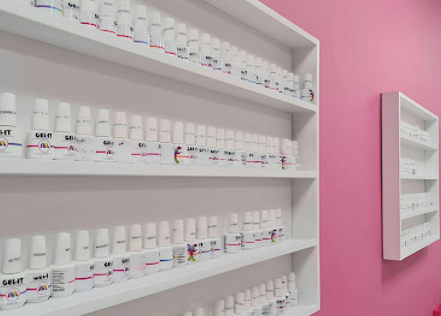 Nail polish shelves at Posh Pamper Specialists in Cape Town, Western Cape, ZA. Vibrant pink wall decor.