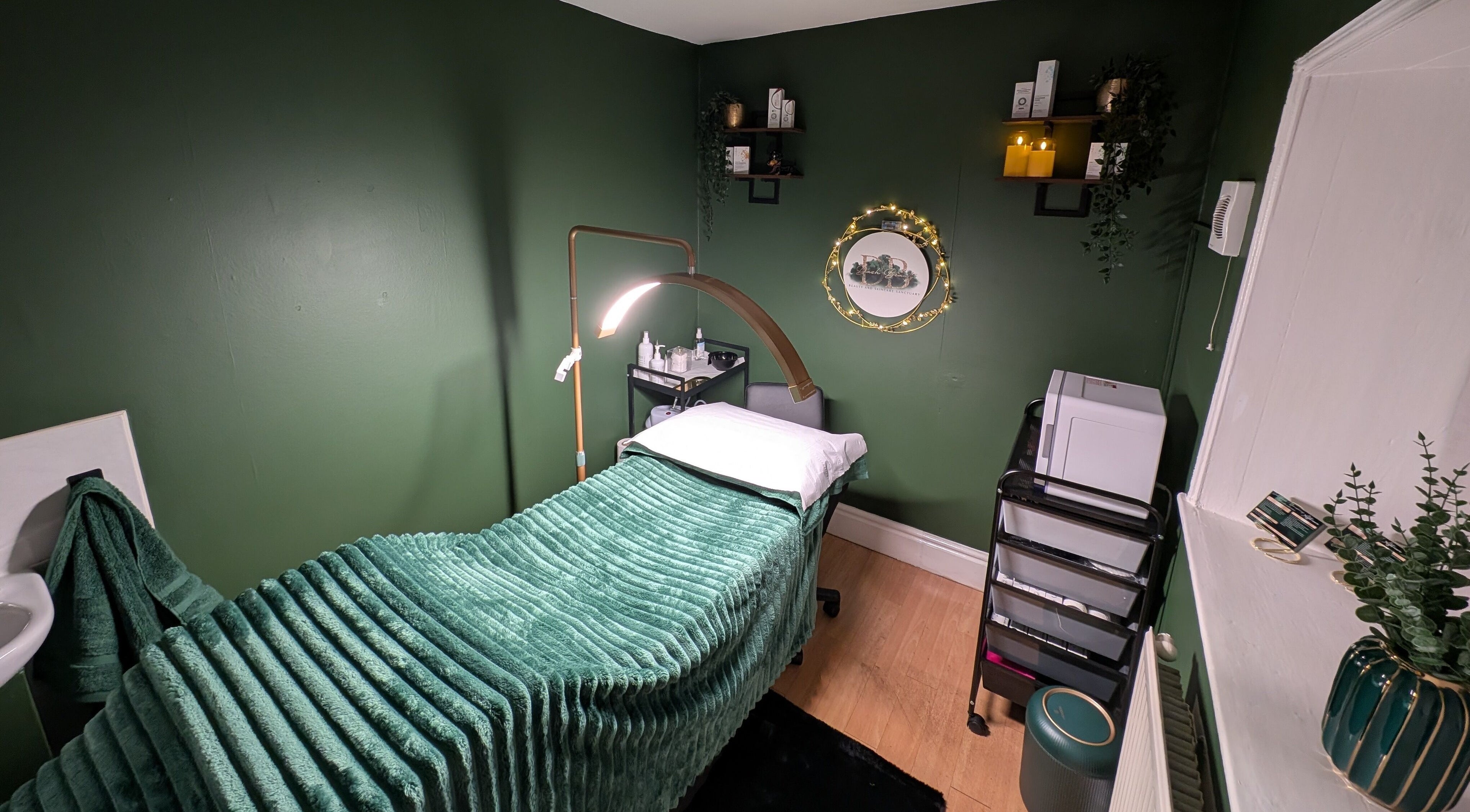 Peaceful spa room at Dash Beauty, South Cave, England, GB, with a green-themed decor and treatment bed.