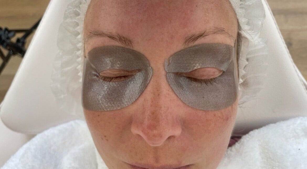 Rejuv by V eye mask treatment in Newcastle, England, GB with hydrating silver patches on closed eyes.