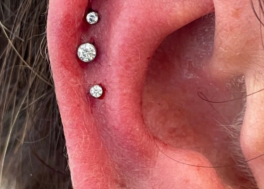 Elegant ear piercings adorned with gems at Rejuv by V, Newcastle, England, GB.