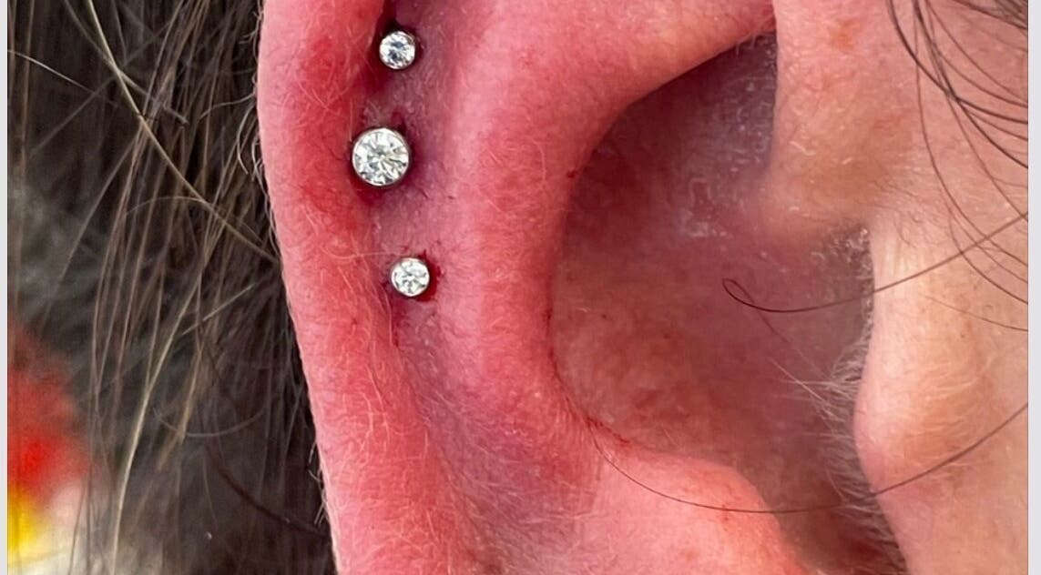 Elegant ear piercings adorned with gems at Rejuv by V, Newcastle, England, GB.