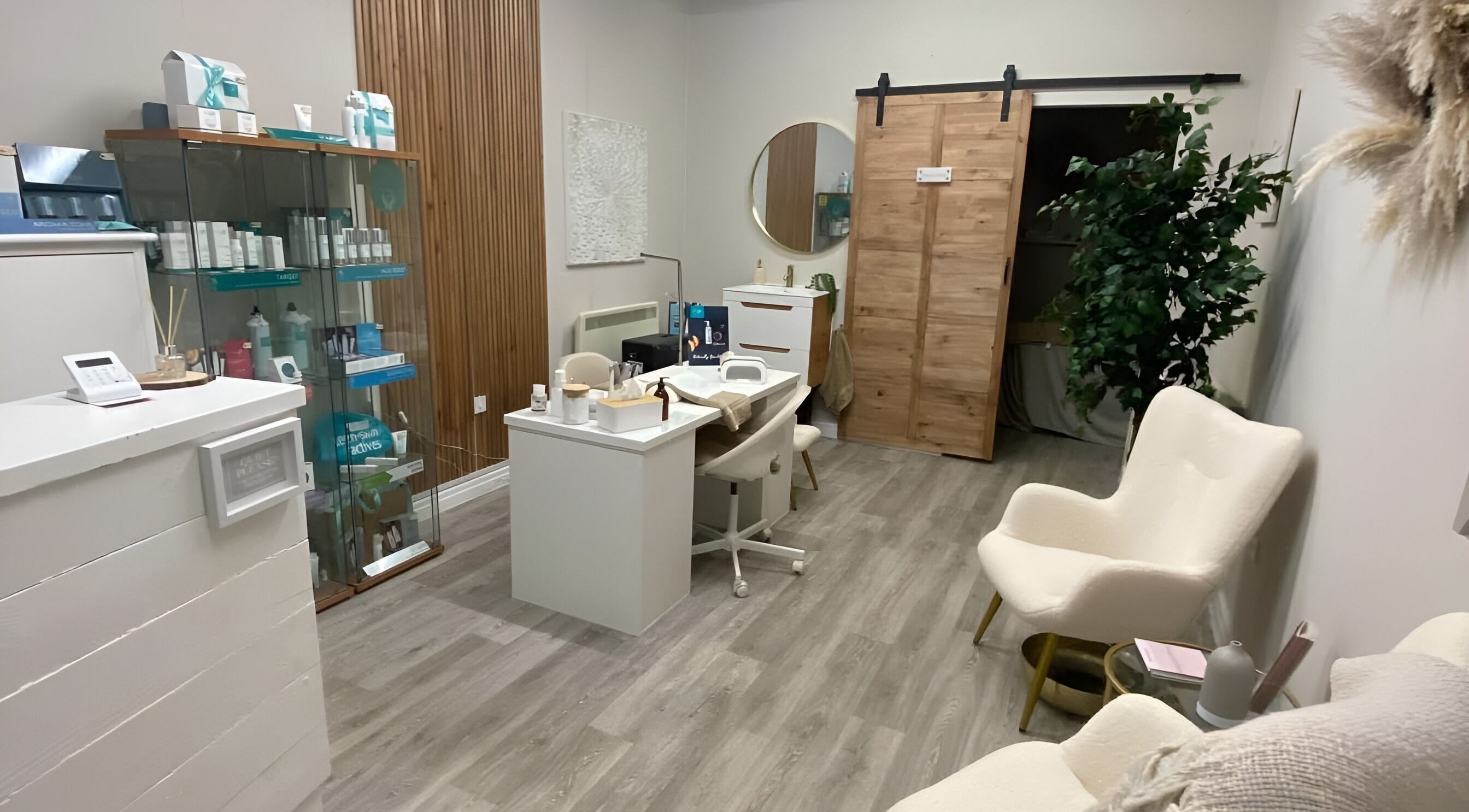Interior of Tranquil Beauty salon in Penmaenmawr, Wales, GB. Modern, serene décor with treatment chair and products.
