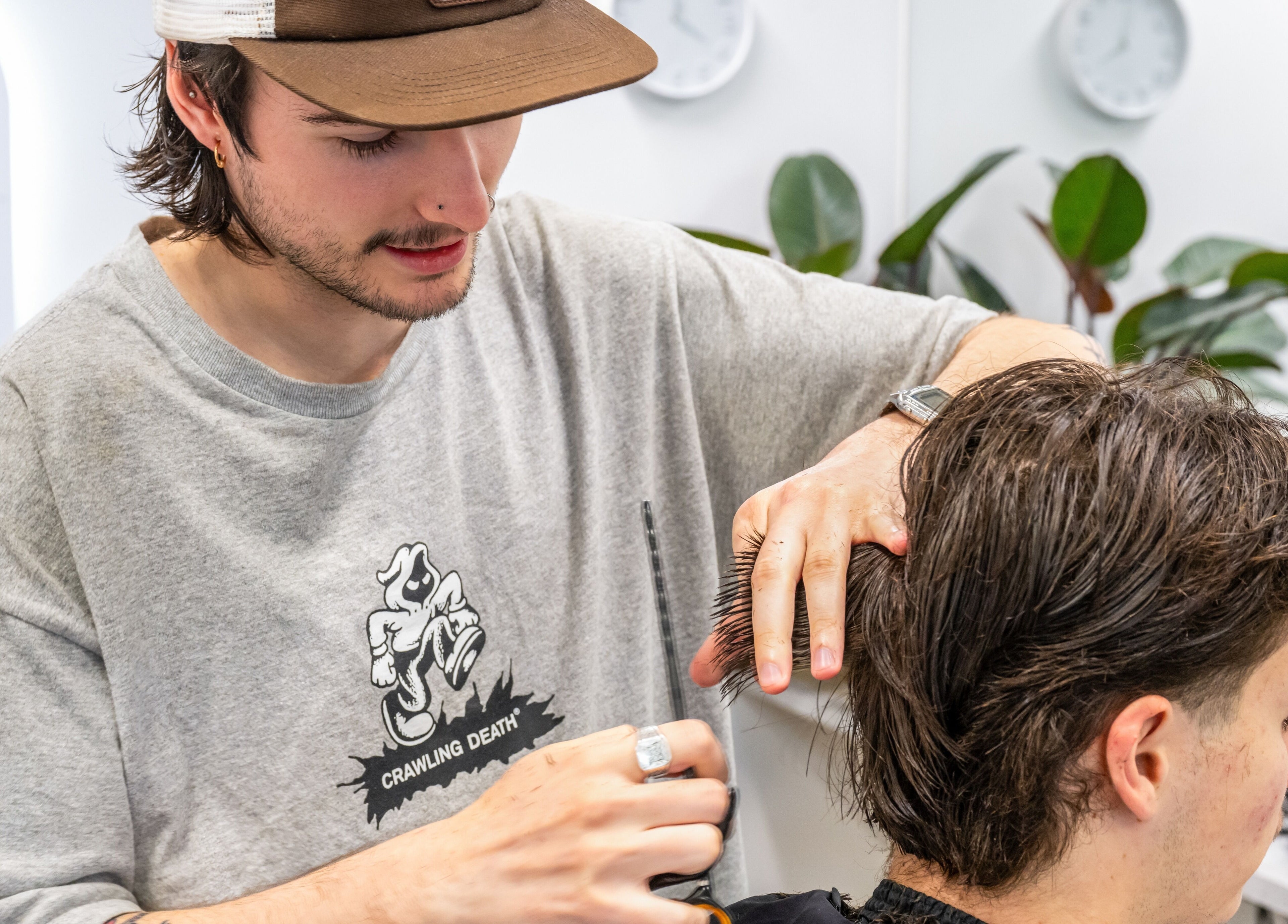 Barber styling hair at Ocean Grove Barbershop, Ocean Grove, VIC, AU. Modern cuts in a trendy setting.
