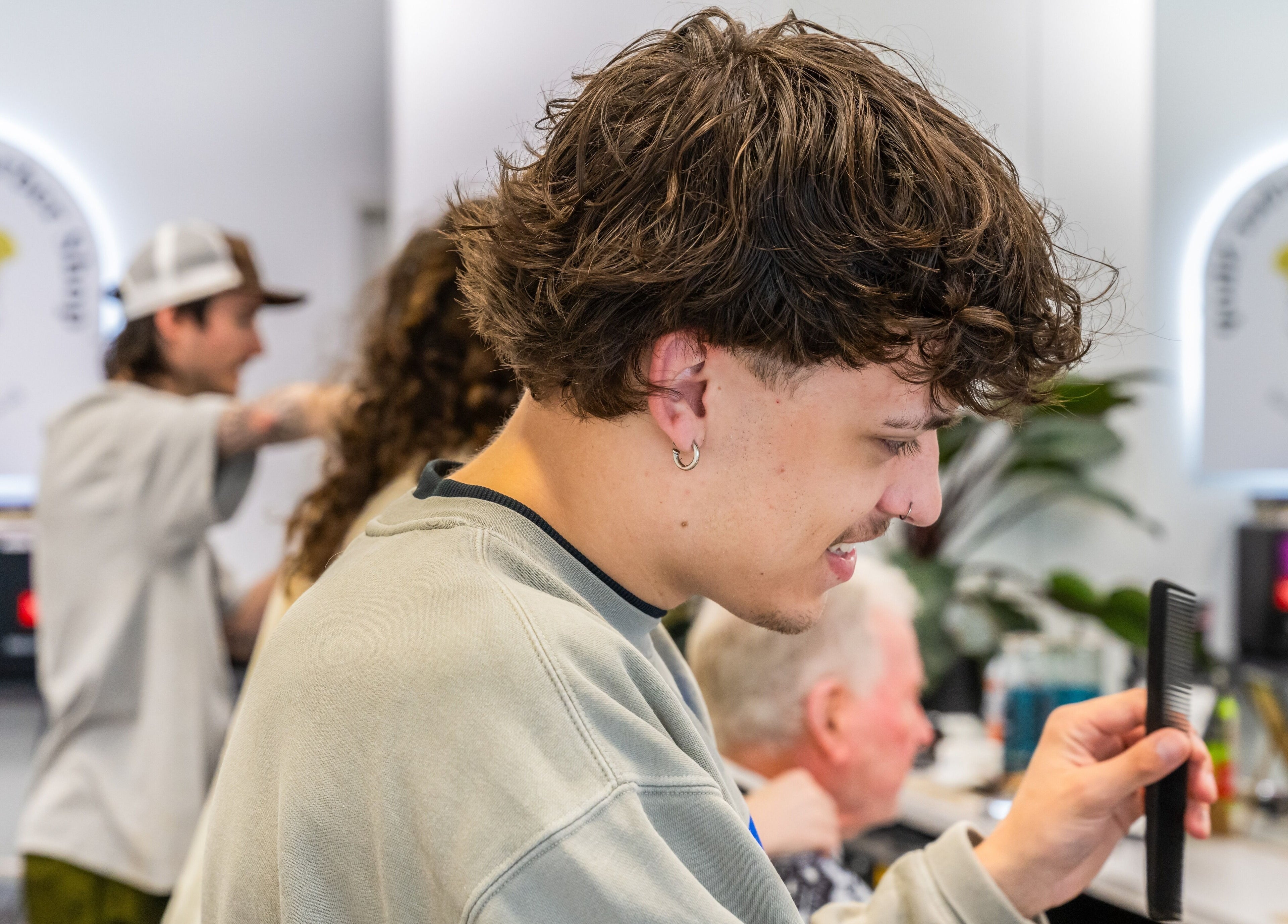 Stylist giving a haircut at Ocean Grove Barbershop in Ocean Grove, VIC, AU. Professional and friendly service.