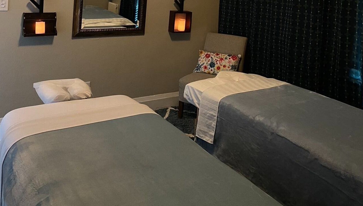 Relaxing massage room in Cindy's Amazing Massage and Spa, Sarasota, Florida, US with cozy decor and twin beds.