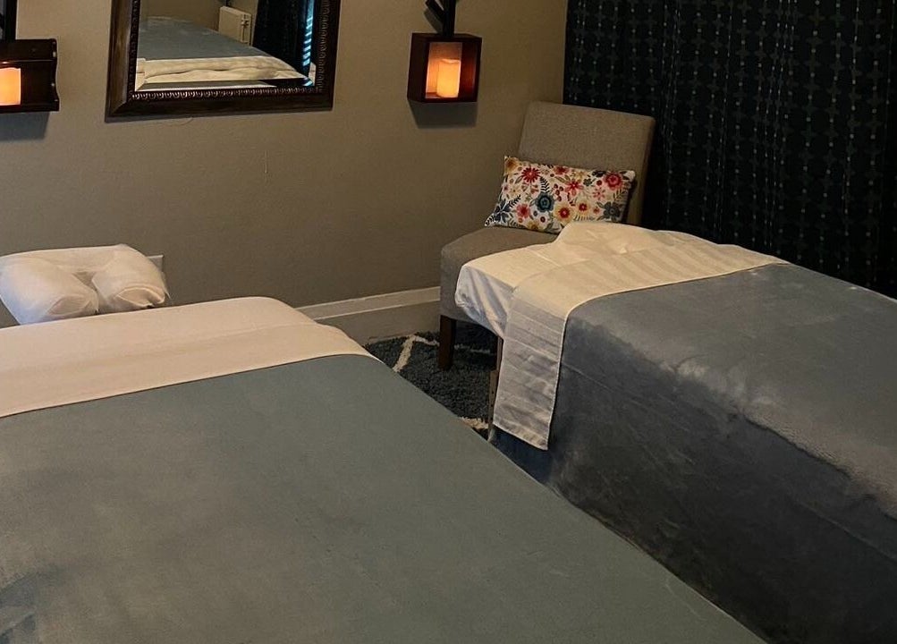 Relaxing massage room in Cindy's Amazing Massage and Spa, Sarasota, Florida, US with cozy decor and twin beds.