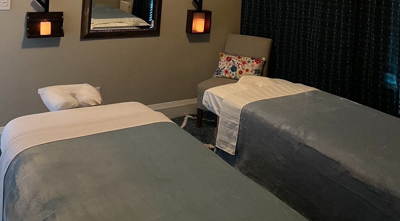 Relaxing massage room in Cindy's Amazing Massage and Spa, Sarasota, Florida, US with cozy decor and twin beds.