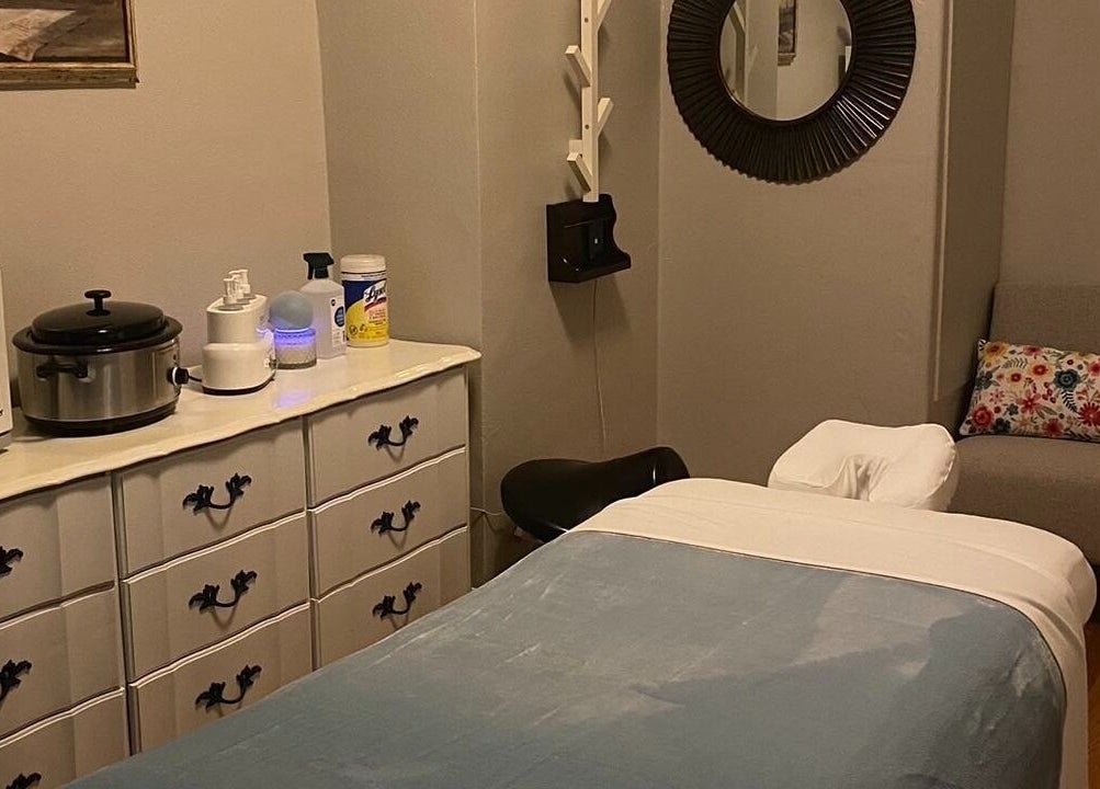 Massage therapy room at Cindy's Amazing Massage and Spa in Sarasota, Florida, US, with massage table and decor.