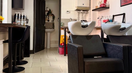 Modern salon interior at Ivor Hairdressing in Stoke-on-Trent, England, GB featuring sleek washing stations.