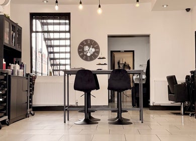 Modern interior of Ivor Hairdressing, Stoke-on-Trent, England, GB, featuring stylish seating and contemporary decor.