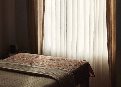 Cozy massage room with soft natural lighting at Alam Wellness Bali, Denpasar, Bali, ID.