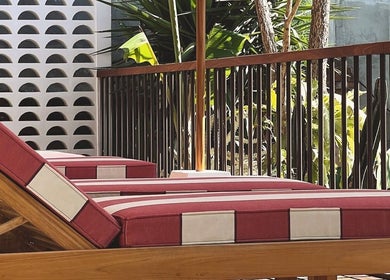 Relaxing lounge chairs at Alam Wellness Bali, Denpasar, Bali, ID, perfect for a tranquil wellness experience.