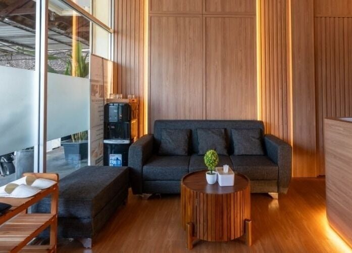 Elegant lounge at Acupuncture Bali, Nusa Dua, featuring a stylish couch and warm decor, Bali, Bali, ID.