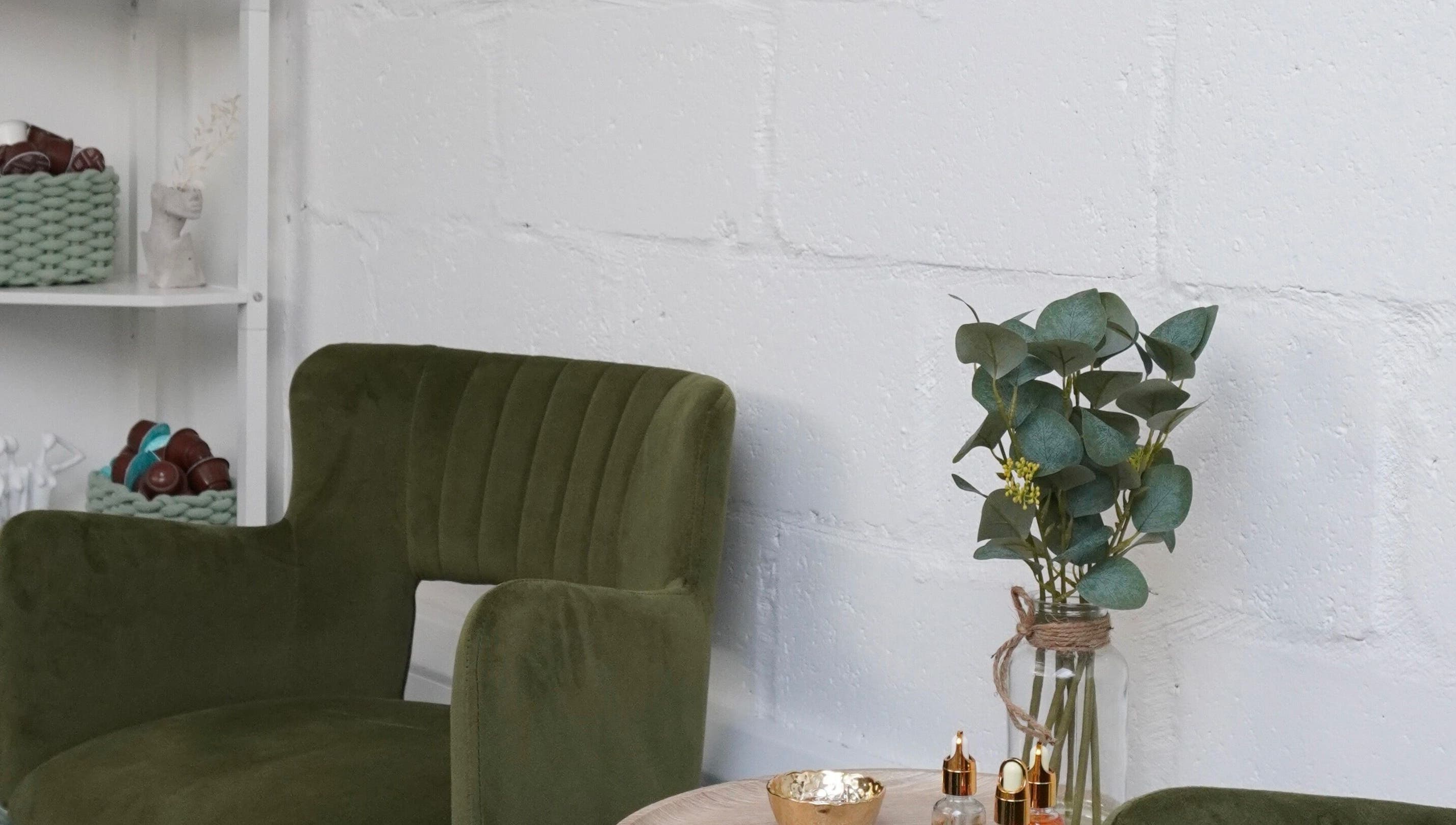 Chic seating area at Touch, Royal Tunbridge Wells, England. Green chair and decor create a tranquil ambiance.