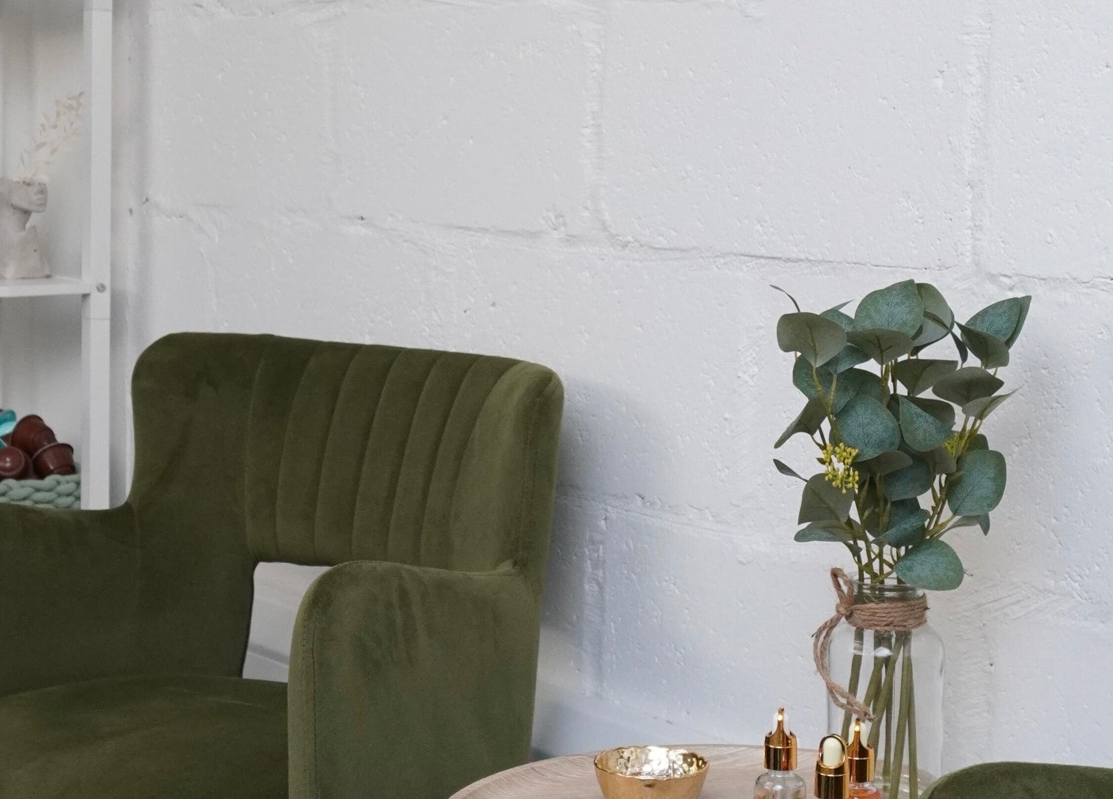 Chic seating area at Touch, Royal Tunbridge Wells, England. Green chair and decor create a tranquil ambiance.