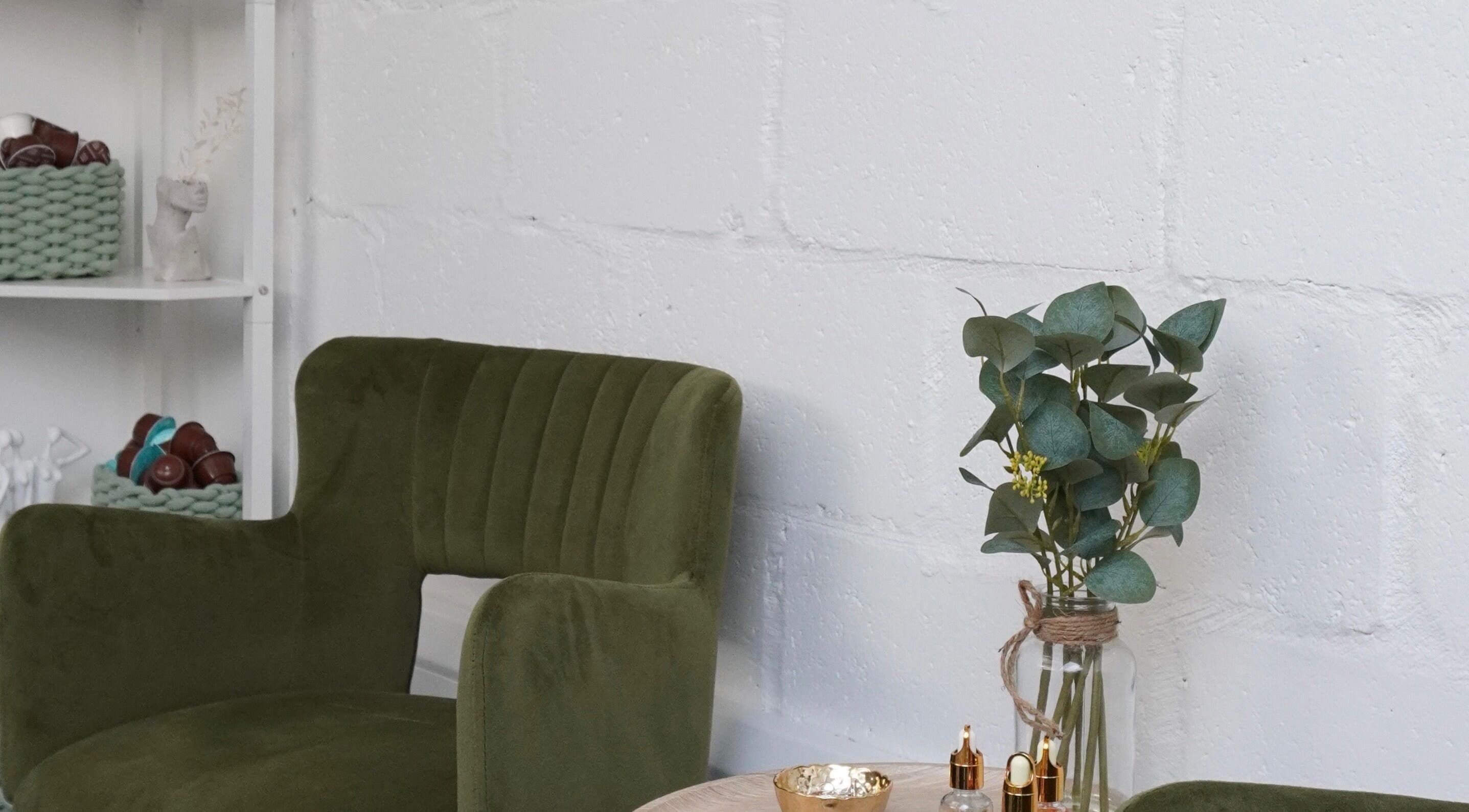 Chic seating area at Touch, Royal Tunbridge Wells, England. Green chair and decor create a tranquil ambiance.
