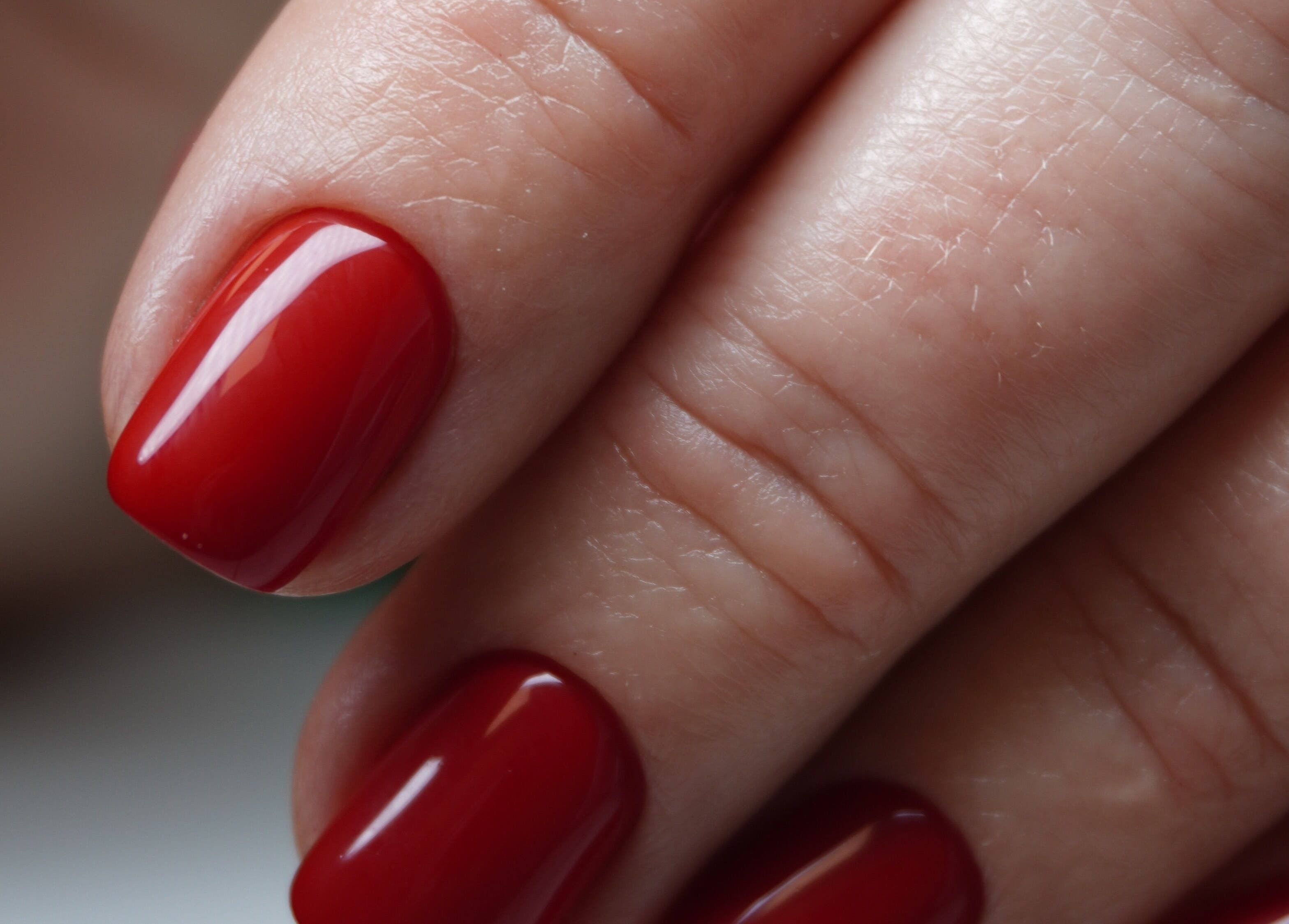 Elegant red manicure at Touch, Royal Tunbridge Wells, England, GB showcasing flawless nail art.