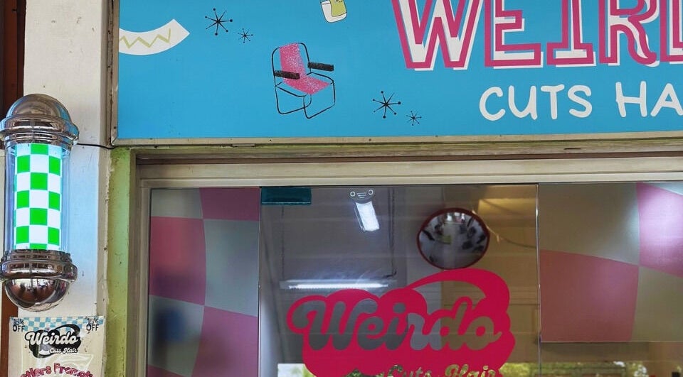 Bright sign of Weirdo Cuts Hair, Singapore, SG, showcasing a creative salon facade.