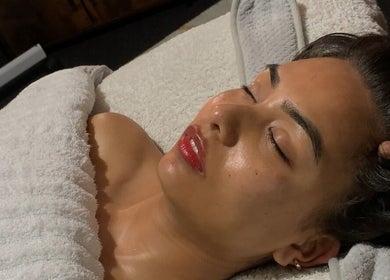 Woman enjoying a serene facial treatment at The Inspired Beauty, Christchurch, Canterbury Region, NZ.