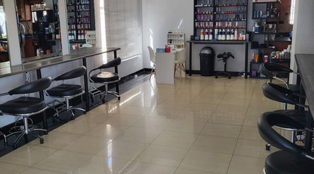 Interior of Sparkle Nail Studio in Roodepoort, Gauteng, ZA, showcasing sleek seating and manicure stations.