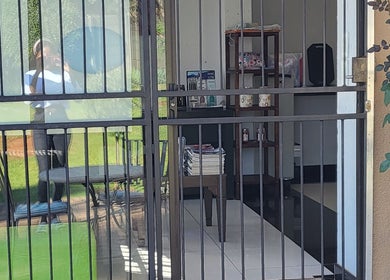 Entrance view of Sparkle Nail Studio in Roodepoort, Gauteng, ZA showcasing stylish interiors behind a glass door.