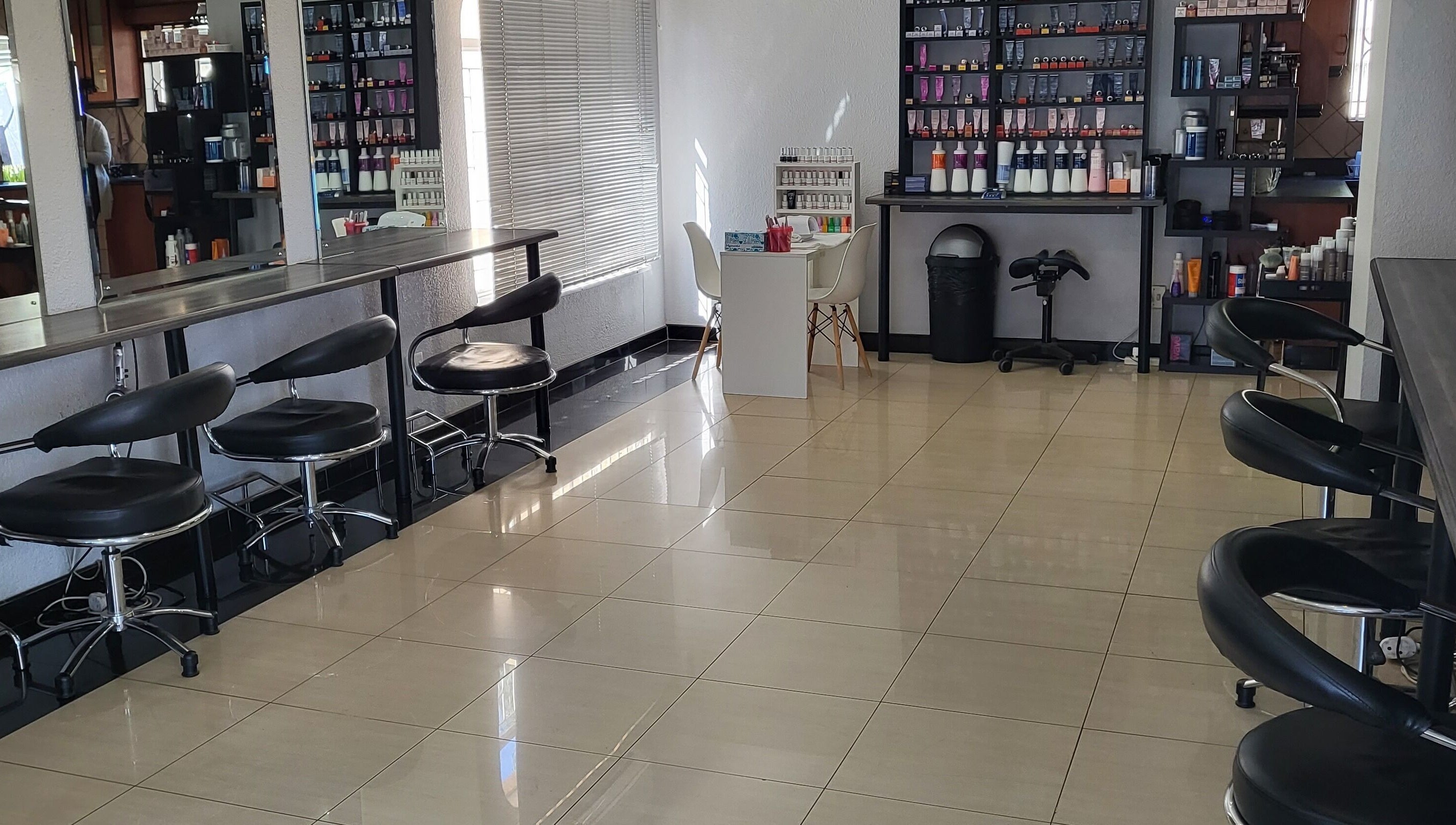 Interior of Sparkle Nail Studio, Roodepoort, Gauteng, ZA showcasing modern salon chairs and product displays.