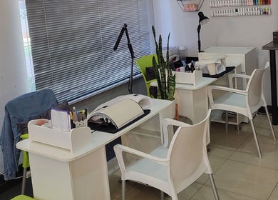 Modern nail stations at Sparkle Nail Studio, Roodepoort, Gauteng, ZA, featuring sleek furniture and nail supplies.