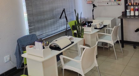 Modern nail stations at Sparkle Nail Studio, Roodepoort, Gauteng, ZA, featuring sleek furniture and nail supplies.