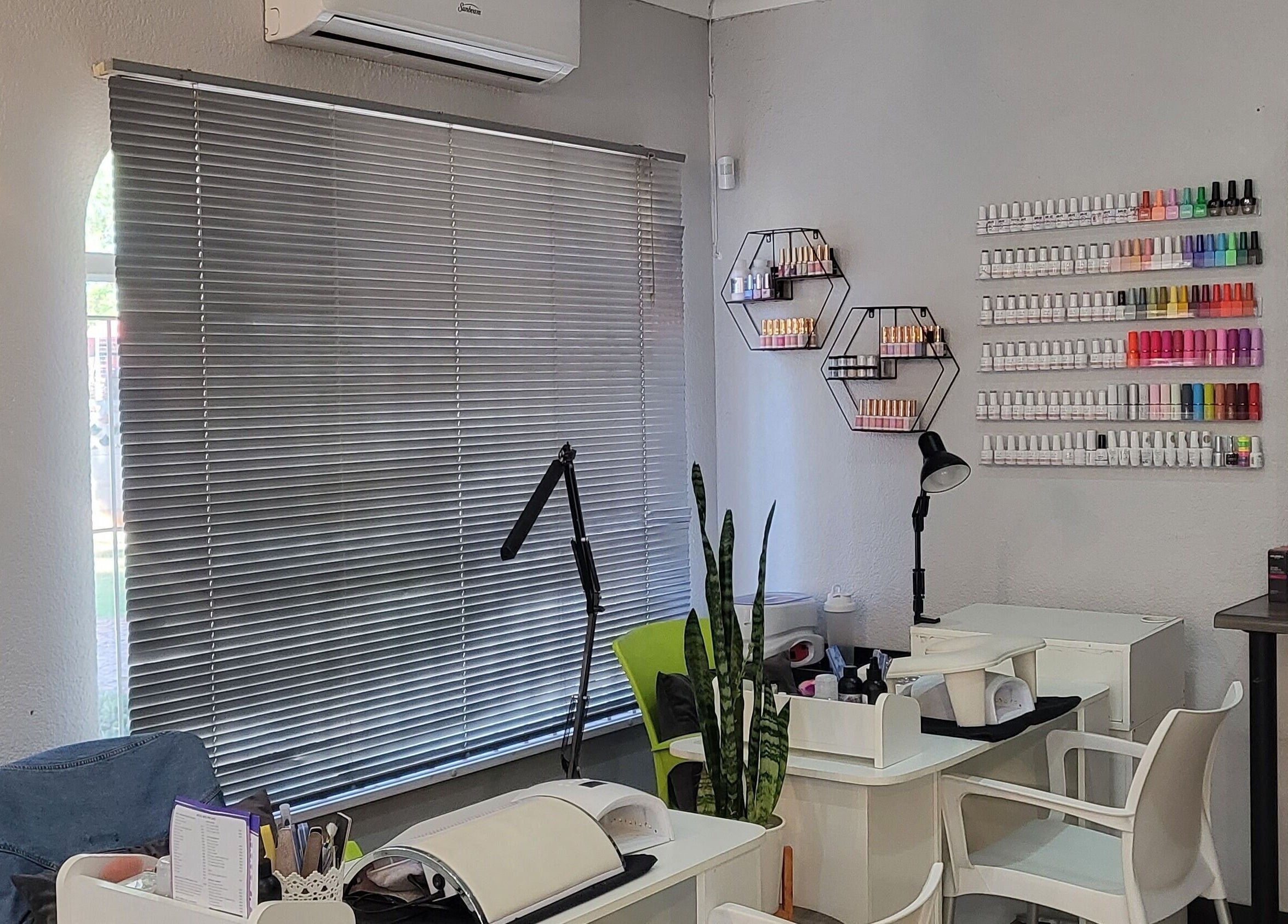 Cozy interior of Sparkle Nail Studio, Roodepoort, Gauteng, ZA, featuring manicure stations and colorful polish display.