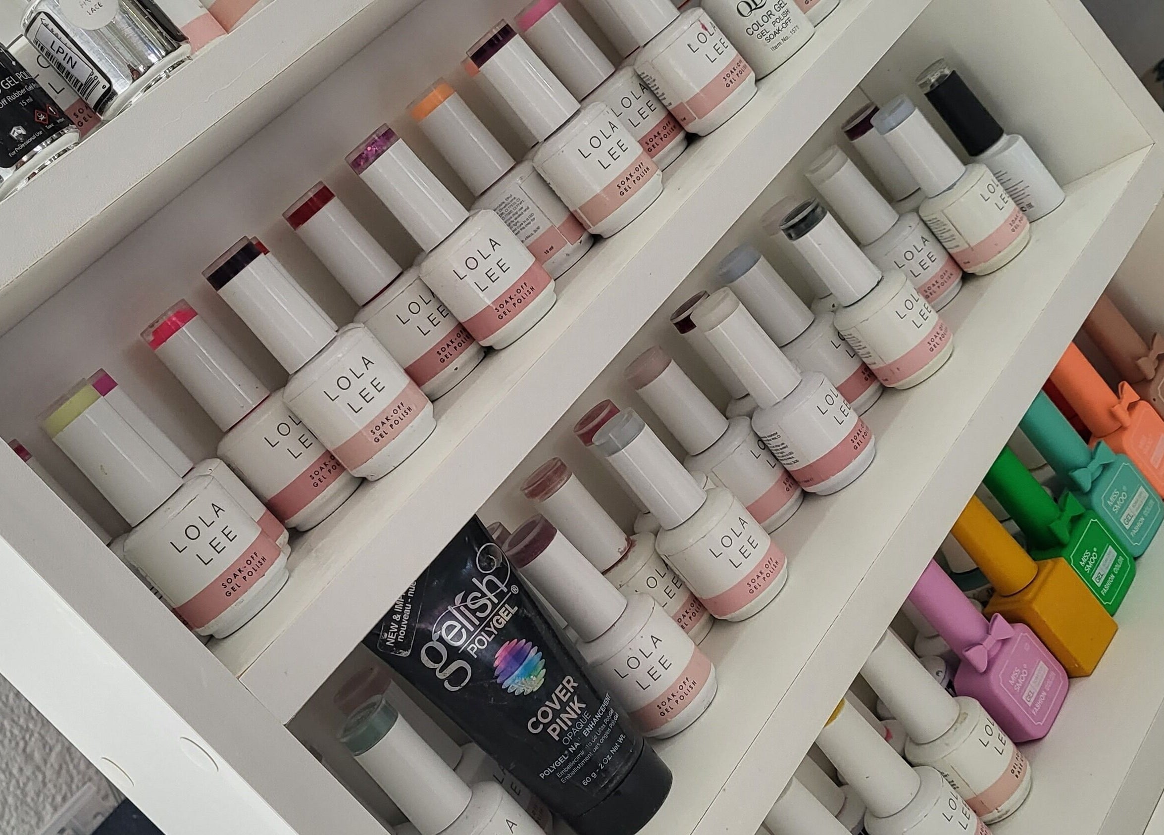 Colorful nail polish display at Sparkle Nail Studio, Roodepoort, Gauteng, ZA, showcasing vibrant gel options.