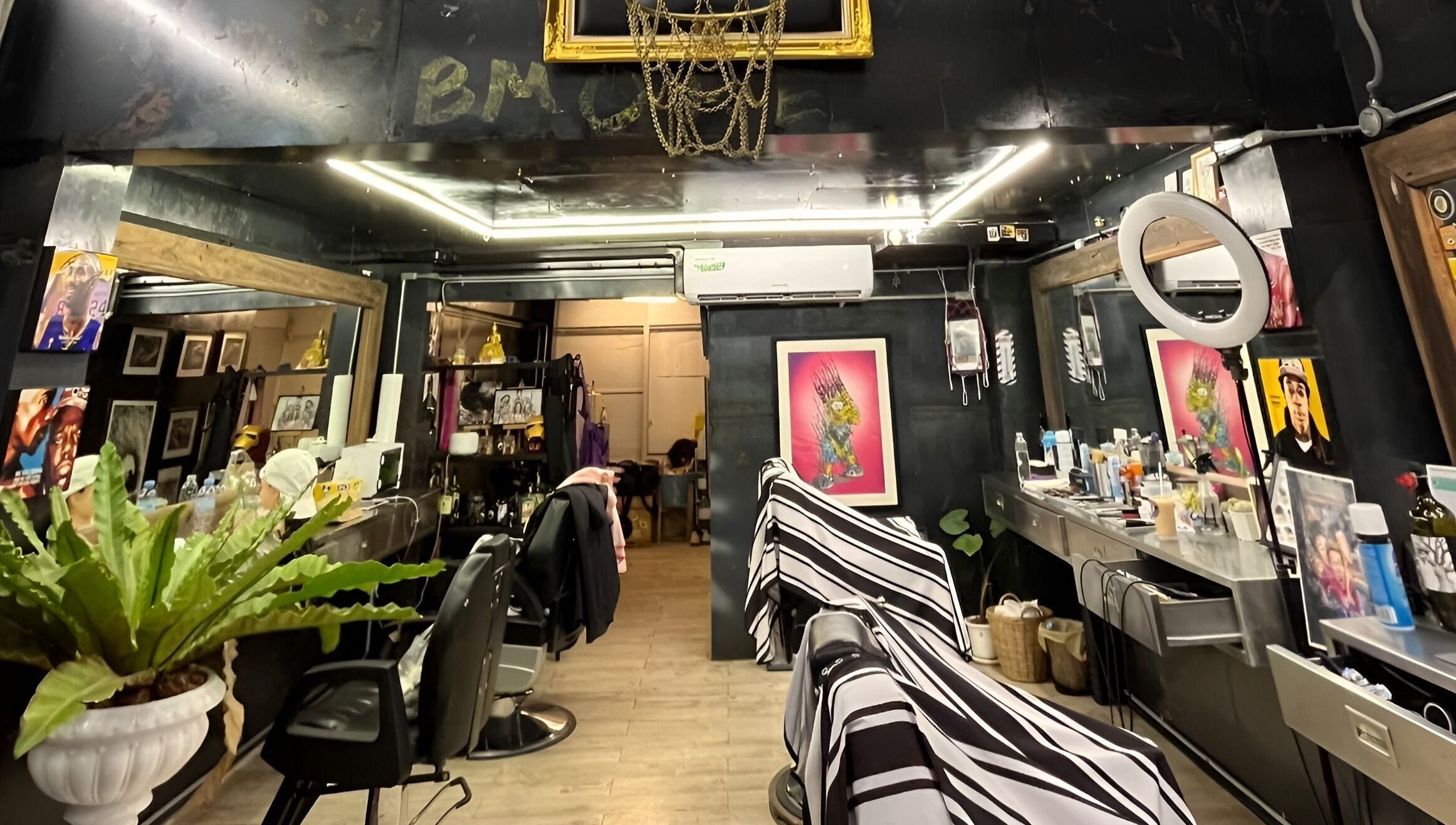 Modern interior of Bmore Barbers Bkk, Krung Thep Maha Nakhon, showcasing sleek barber chairs and stylish decor.