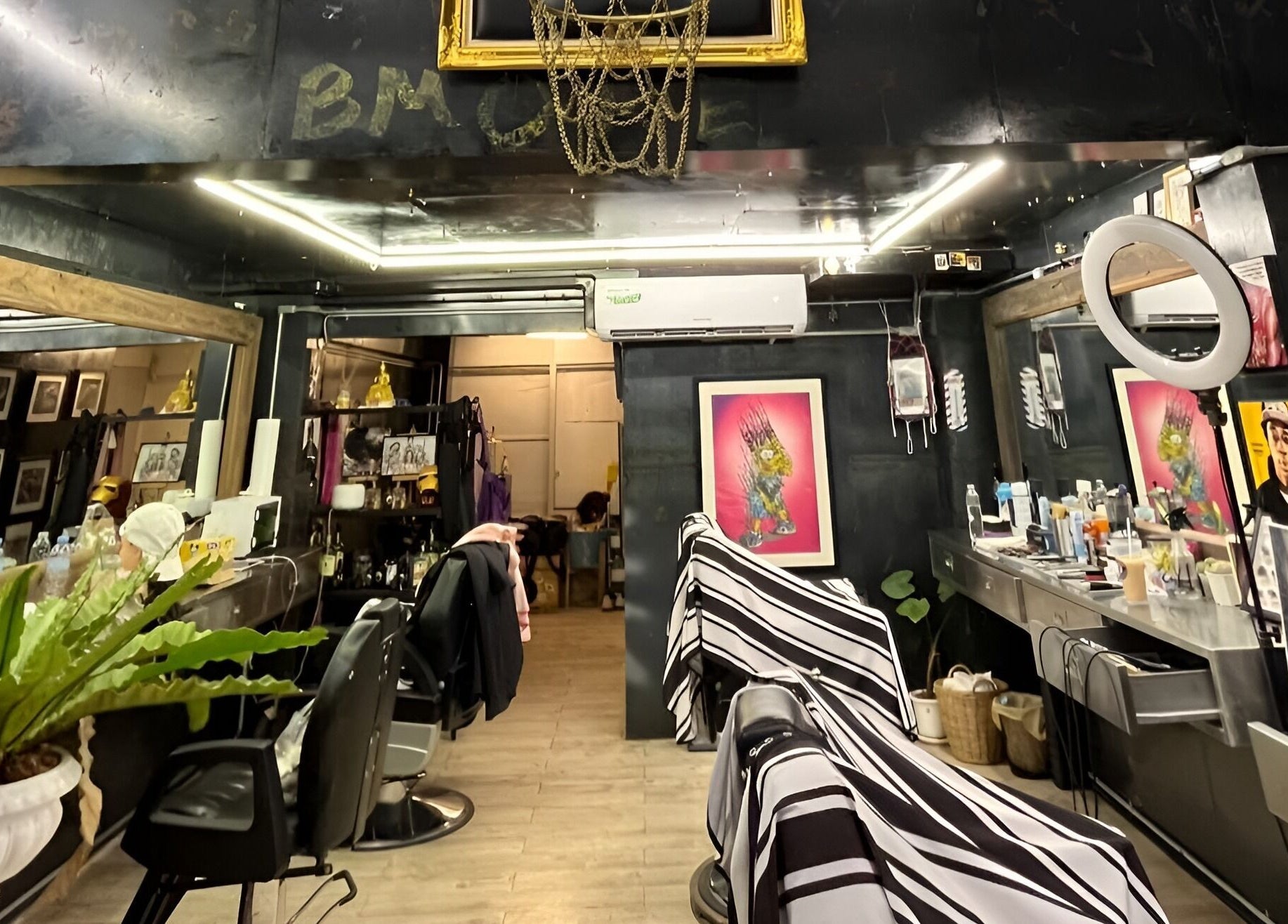 Modern interior of Bmore Barbers Bkk, Krung Thep Maha Nakhon, showcasing sleek barber chairs and stylish decor.