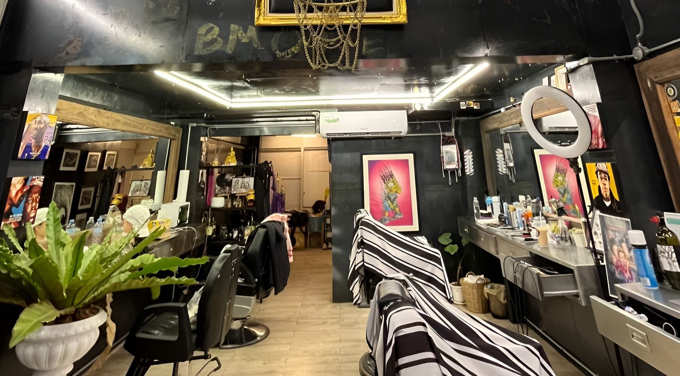 Modern interior of Bmore Barbers Bkk, Krung Thep Maha Nakhon, showcasing sleek barber chairs and stylish decor.