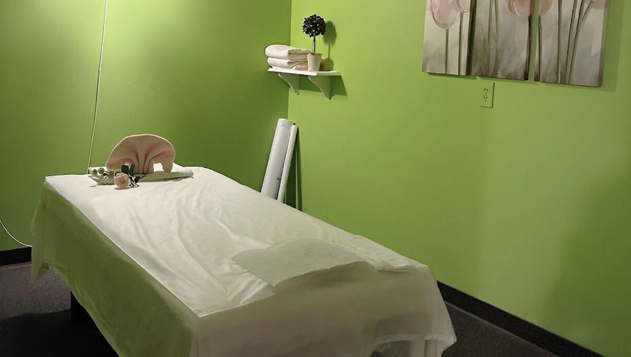 Tranquil massage room with green walls at Health Care Massage in Bozeman, Montana, US.