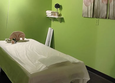 Tranquil massage room with green walls at Health Care Massage in Bozeman, Montana, US.