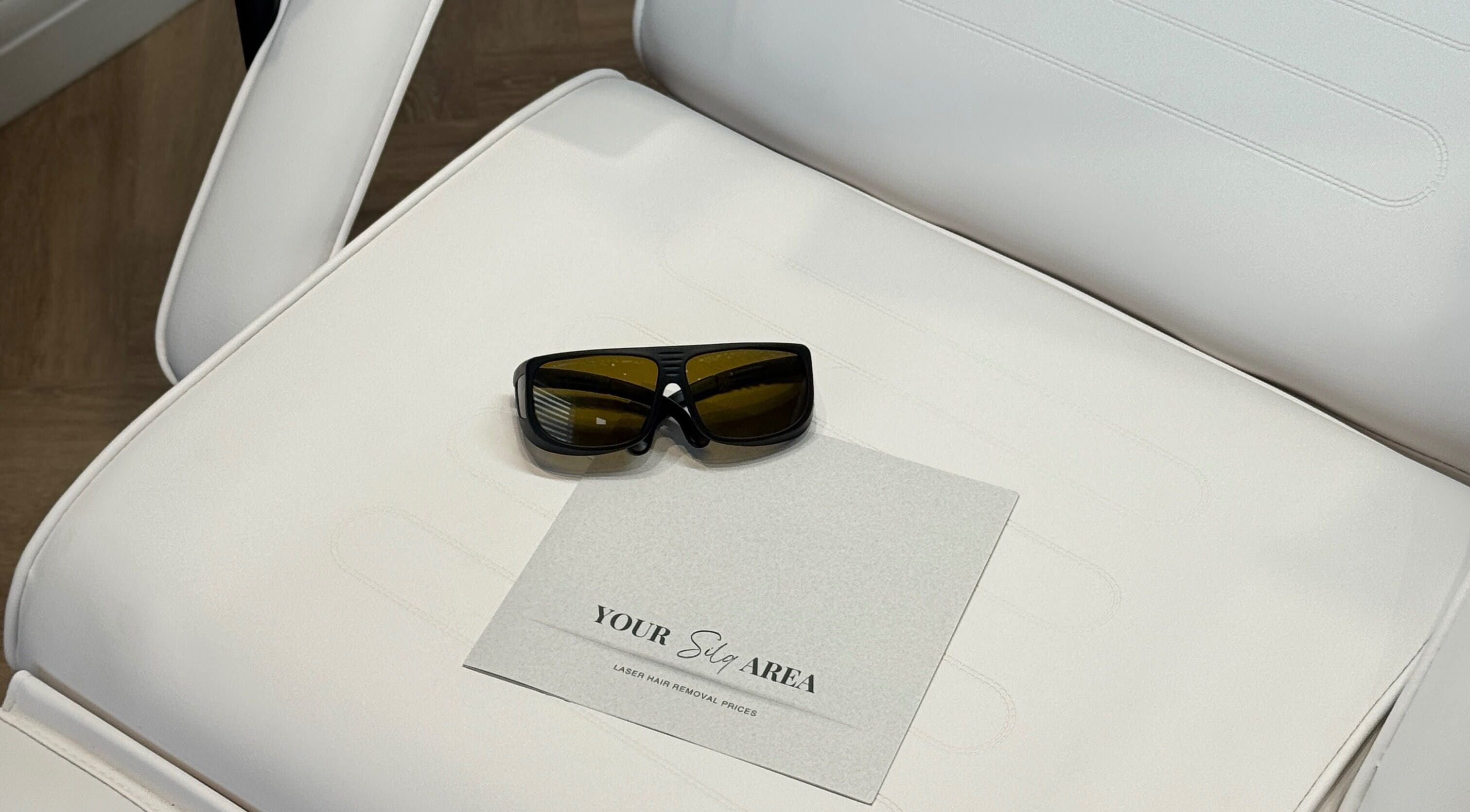 Sunglasses and spa menu on a white chair at Silqera, Sheffield, England, GB.