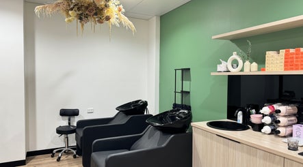 Modern salon wash station at Studio Deja Wu, Melbourne, Victoria, AU with black chairs and stylish decor.
