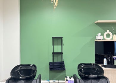 Elegant shampoo area at Studio Deja Wu, Melbourne, Victoria, AU with sleek black basins and modern decor.