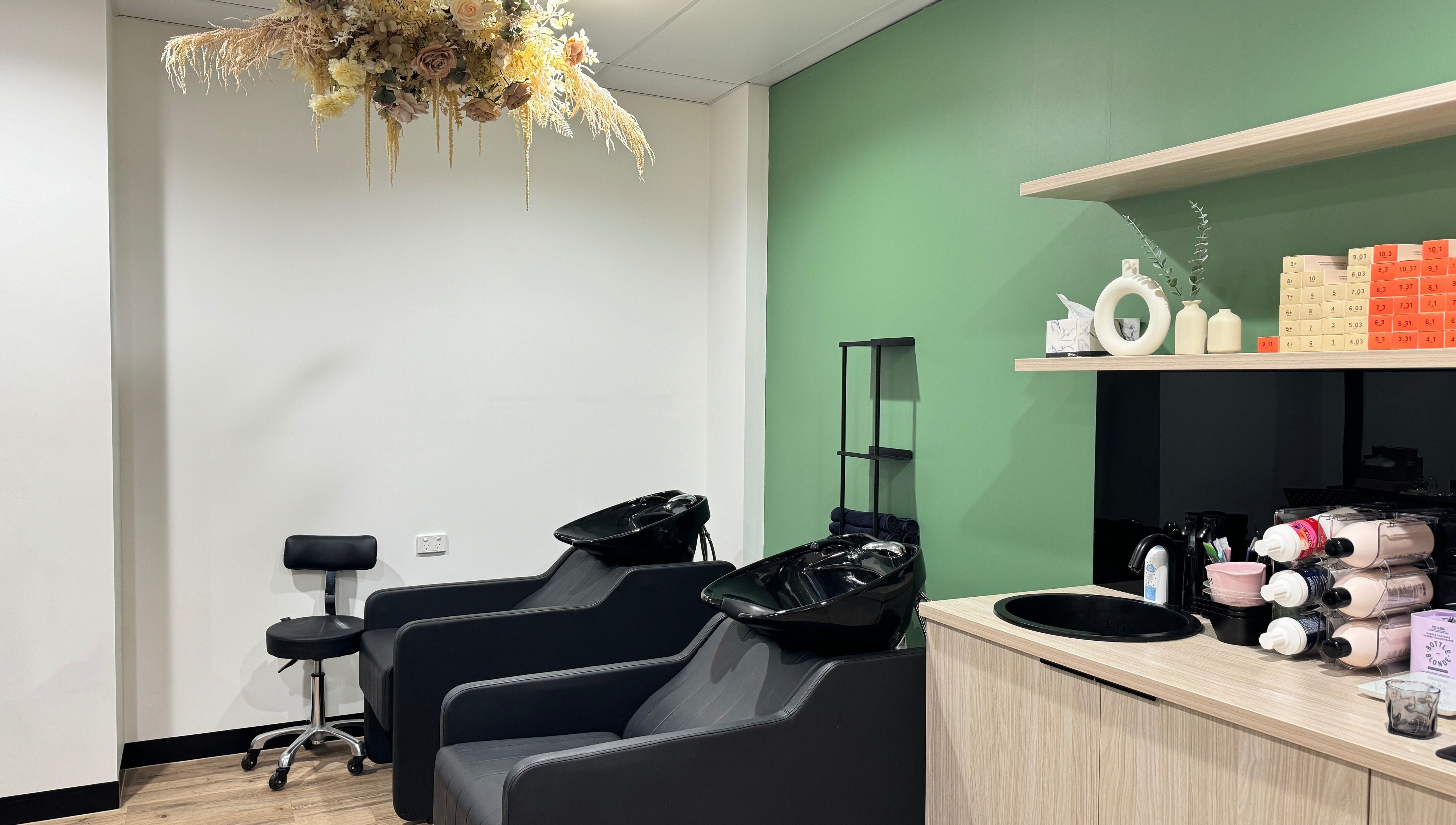 Chic wash station at Studio Deja Wu, Melbourne, Victoria, AU with elegant floral decor and modern styling chairs.