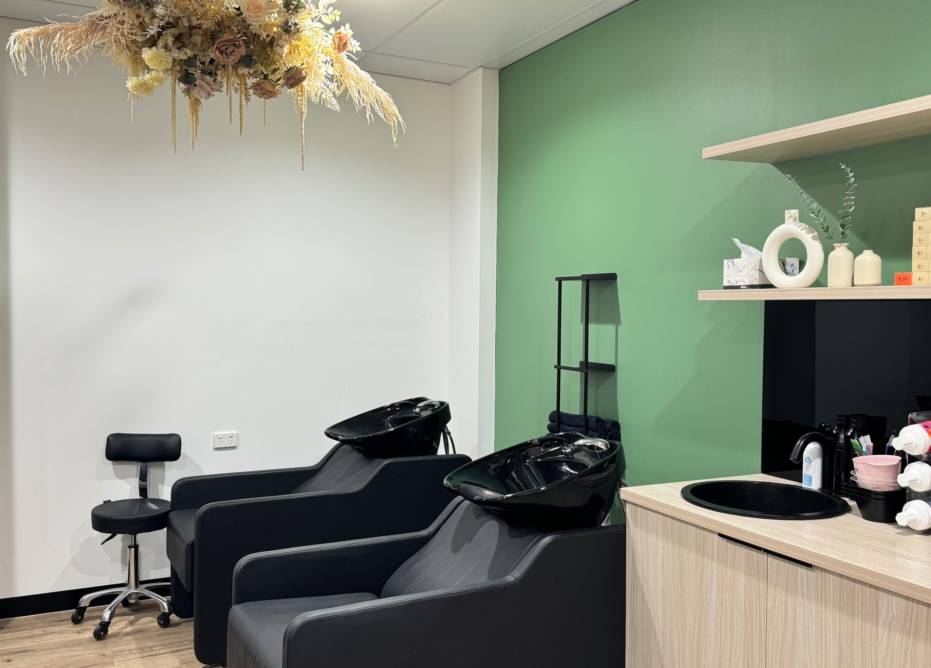 Chic wash station at Studio Deja Wu, Melbourne, Victoria, AU with elegant floral decor and modern styling chairs.