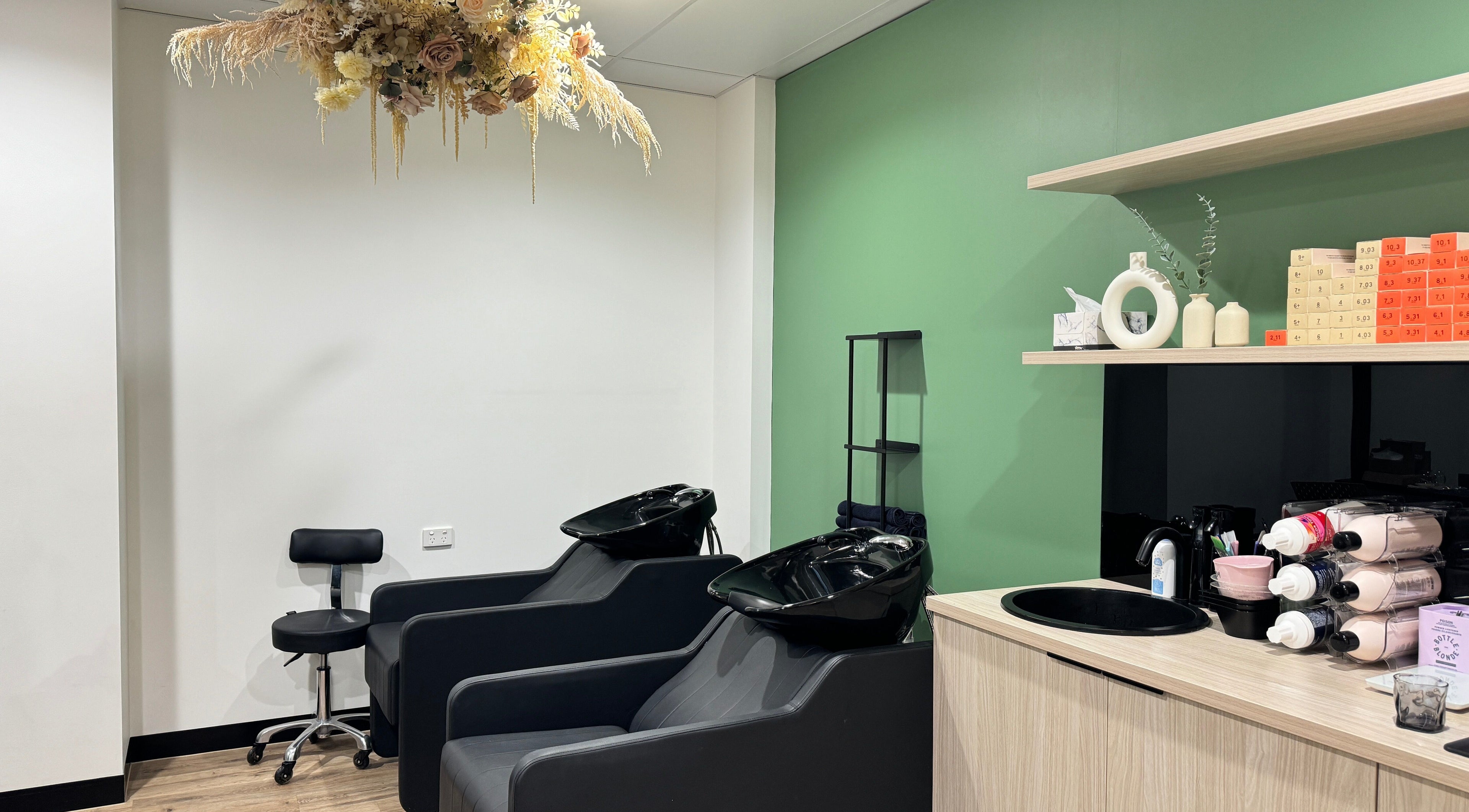 Chic wash station at Studio Deja Wu, Melbourne, Victoria, AU with elegant floral decor and modern styling chairs.