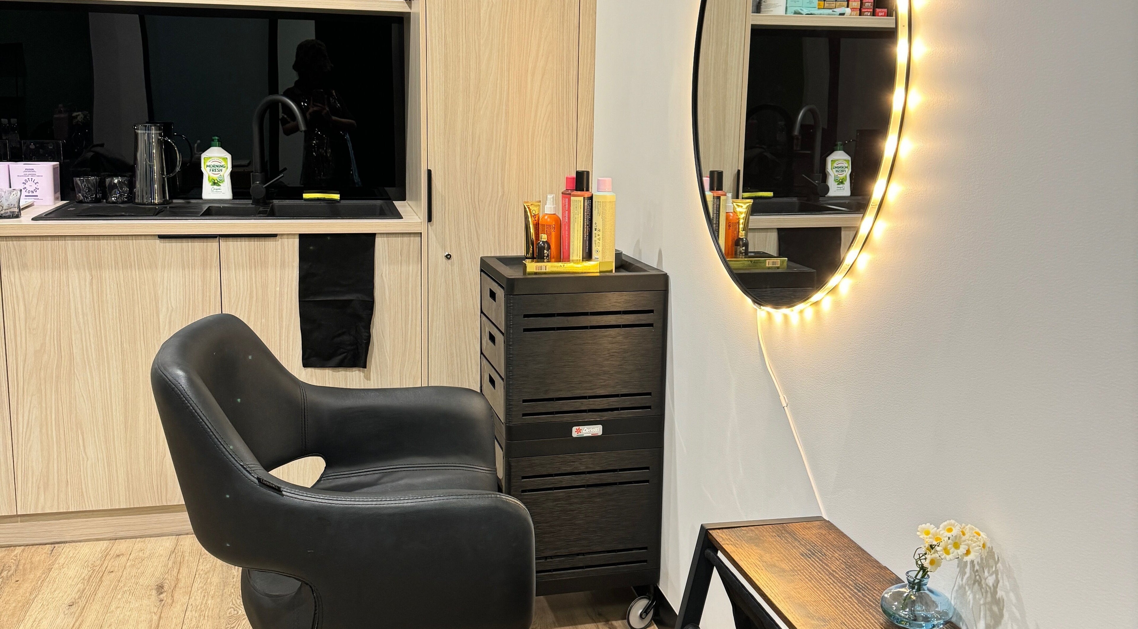 Stylish beauty station at Studio Deja Wu, Melbourne, Victoria, AU featuring a lit mirror and sleek chair.