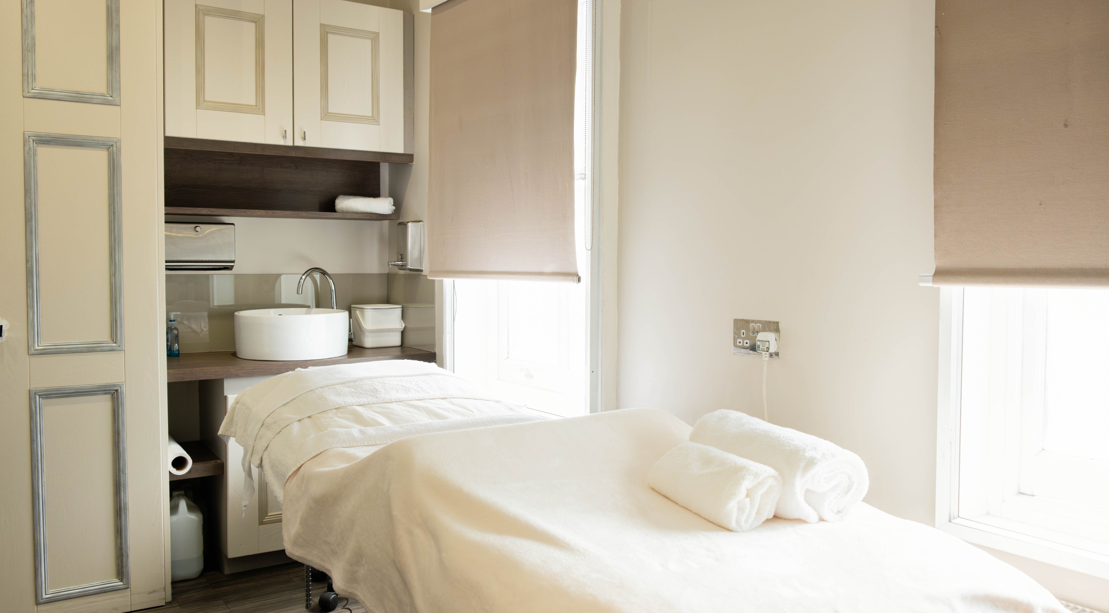 Calm treatment room at Linda Meredith, Knightsbridge in London, England, GB, showcasing a spa bed and sleek decor.