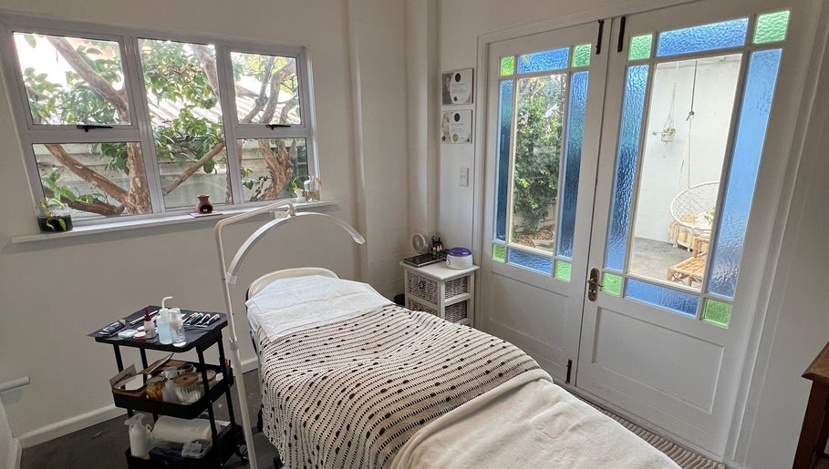 Tranquil treatment room at Lada Beauty Studio in Cape Town, Western Cape, ZA with lush garden views.