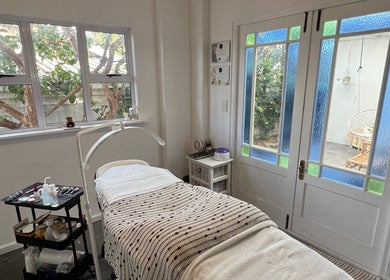 Tranquil treatment room at Lada Beauty Studio in Cape Town, Western Cape, ZA with lush garden views.