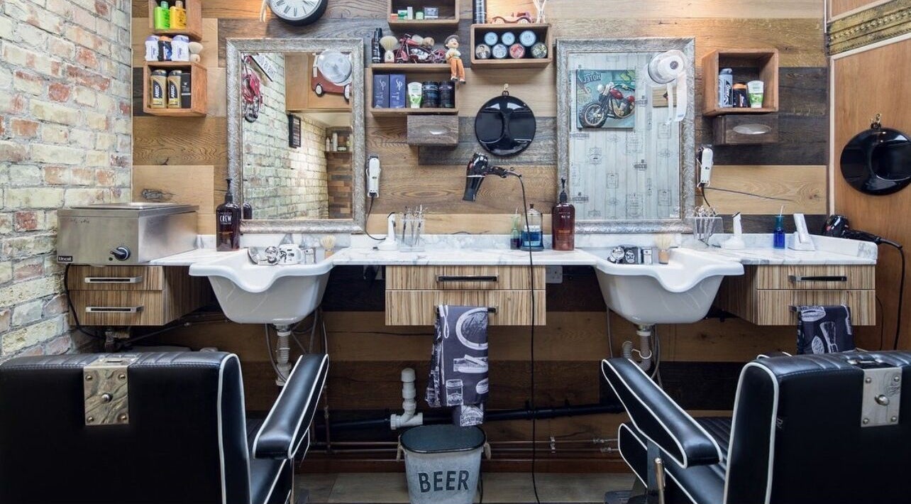 Interior of Pasha Barbers, Bank in London, England, GB showcasing rustic barber chairs and vintage decor.