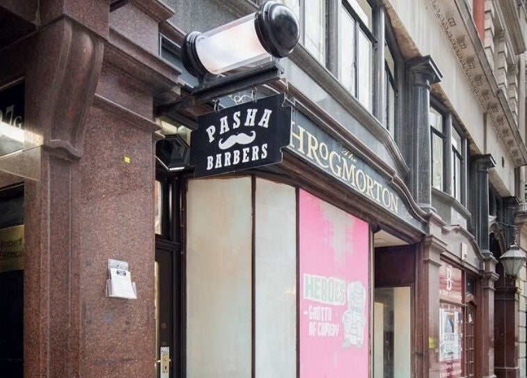 Exterior of Pasha Barbers, Bank located in London, England, GB with iconic signage on a busy street.